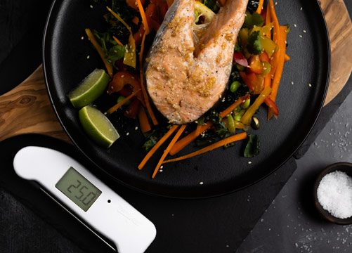 Red Thermapen, digital thermometer being used to take the internal temperature of chicken